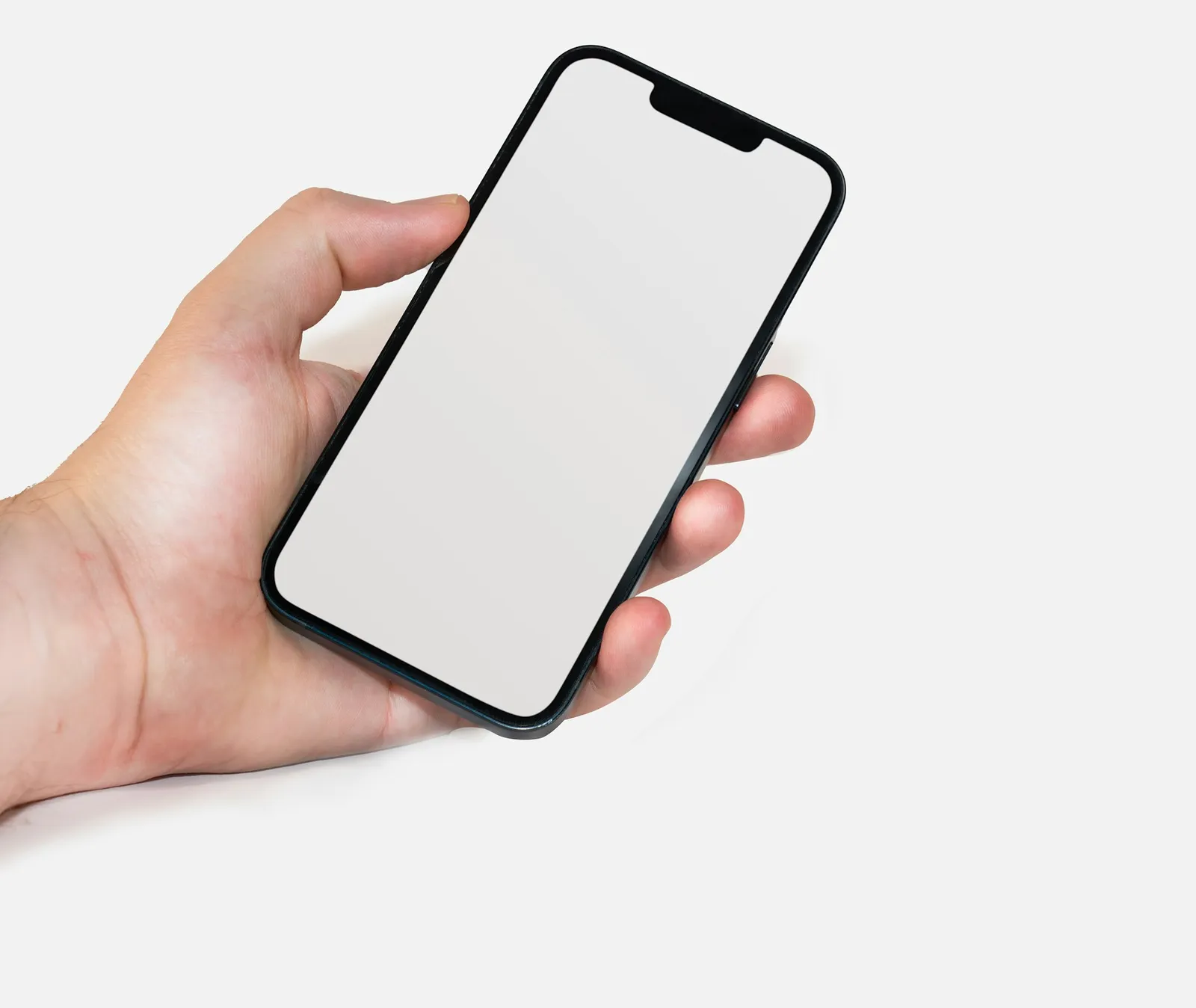 A hand holding a smartphone with a blank white screen.