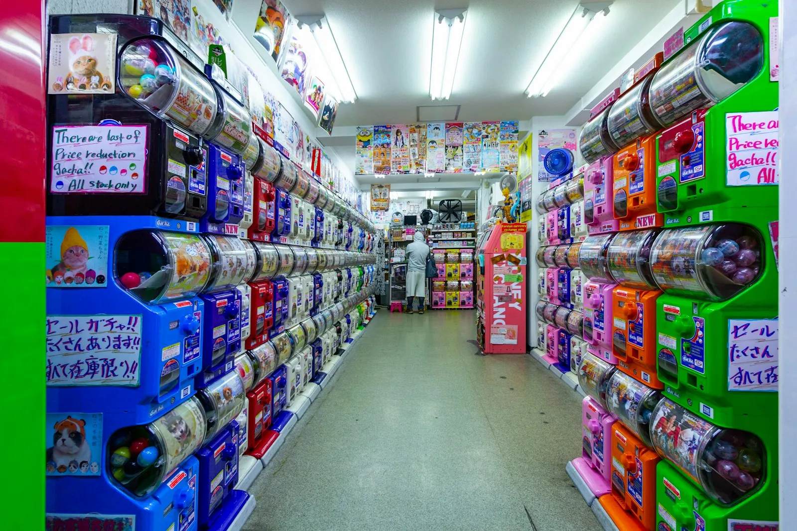 Aisles of packaged goods on shelves in a Japanese shop.